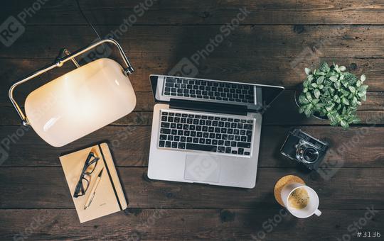 Top view of a hipster workdesk or home office with Laptop or Notebook, lamp, coffee cup and vinatge camera. New Business concept image  : Stock Photo or Stock Video Download rcfotostock photos, images and assets rcfotostock | RC Photo Stock.: