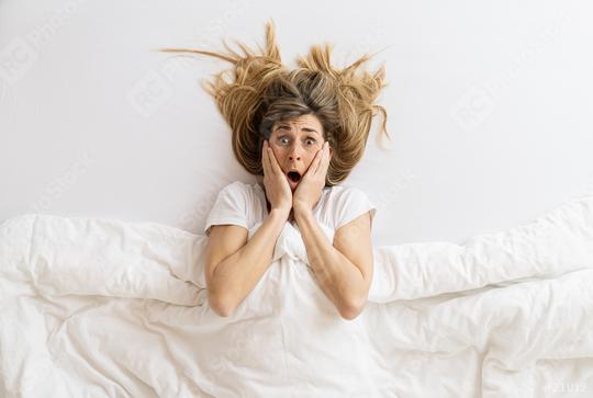 Top view of a shocked woman that looks at camera while lying in bed under blanket, copyspace for your individual text.  : Stock Photo or Stock Video Download rcfotostock photos, images and assets rcfotostock | RC Photo Stock.: