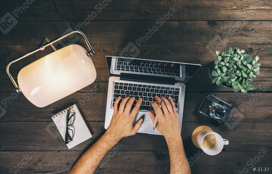 Top view of Businessman using Laptop at home office with lamp, coffee cup and camera. Overhead View concept image  : Stock Photo or Stock Video Download rcfotostock photos, images and assets rcfotostock | RC Photo Stock.: