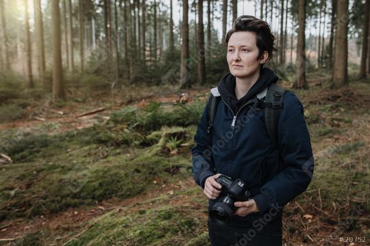 Tourist is in a beautiful forest and enjoys the great sight. The person holds a camera and is a photographer.  : Stock Photo or Stock Video Download rcfotostock photos, images and assets rcfotostock | RC Photo Stock.: