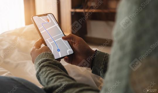 Tourist using GPS map navigation app on smartphone screen to get direction to destination address in the city at a hotel room, travel and technology concept image  : Stock Photo or Stock Video Download rcfotostock photos, images and assets rcfotostock | RC Photo Stock.: