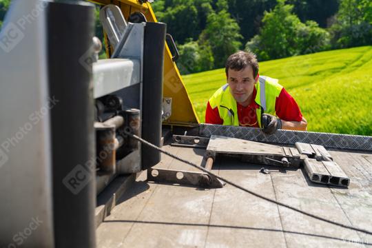 Tow truck driver uses a winch on a tow truck to tow a car  : Stock Photo or Stock Video Download rcfotostock photos, images and assets rcfotostock | RC Photo Stock.:
