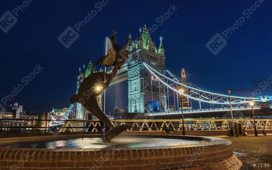 Tower Bridge and statue of a dolphin with girl playing at night in London.  : Stock Photo or Stock Video Download rcfotostock photos, images and assets rcfotostock | RC Photo Stock.: