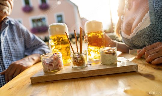 Traditional Bavarian Obatzda with pretzels and radishes and beer mugs, senior man and woman in the background at beer garden or oktoberfest, Munich, Germany  : Stock Photo or Stock Video Download rcfotostock photos, images and assets rcfotostock | RC Photo Stock.: