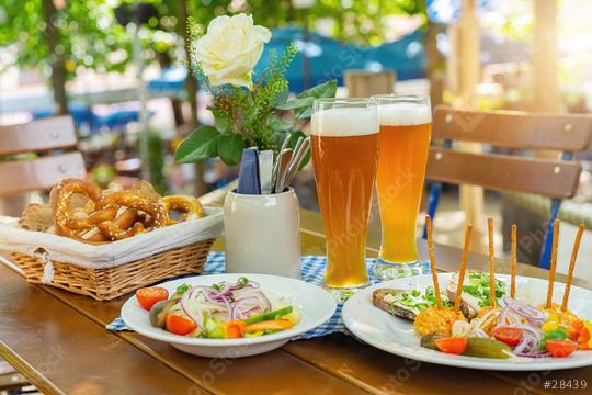 Traditional beer garden food with obatzter beer mugs with fresh pretzels or brezen and bread at Oktoberfest, Munich, Germany  : Stock Photo or Stock Video Download rcfotostock photos, images and assets rcfotostock | RC Photo Stock.: