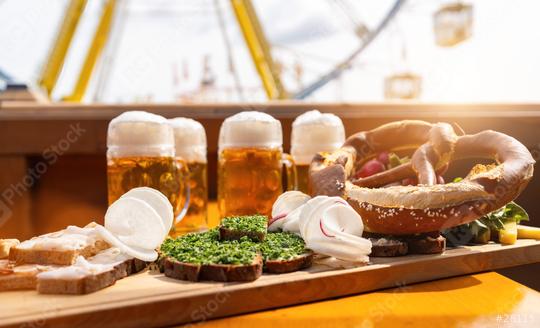 Traditional German food and beer mugs on a wooden tray with ferris wheel ride in the background at oktoberfest or  dult in germany  : Stock Photo or Stock Video Download rcfotostock photos, images and assets rcfotostock | RC Photo Stock.: