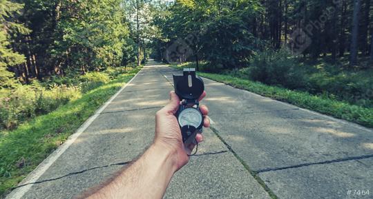 Travel Concept man hand hold Compass on the road in the outback. Point of view shot   : Stock Photo or Stock Video Download rcfotostock photos, images and assets rcfotostock | RC Photo Stock.: