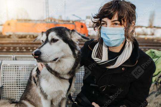 Travel with dog during pandemic. Casual Woman is waiting for the train with her dog on the platform and is wearing a face mask because of the coronavirus. Lovely  und happy friendship with your pet  : Stock Photo or Stock Video Download rcfotostock photos, images and assets rcfotostock | RC-Photo-Stock.: