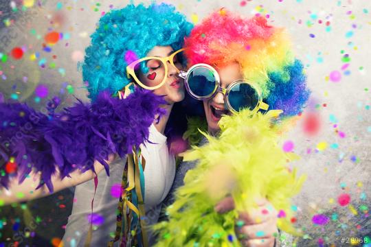 Two cheerful women dressed in colorful wigs, oversized glasses, feather boas, and surrounded by confetti, enjoying a fun and vibrant party atmosphere filled with laughter and celebration  : Stock Photo or Stock Video Download rcfotostock photos, images and assets rcfotostock | RC Photo Stock.: