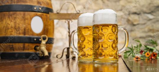 Two mugs of beer with foam and wooden barrel stand on the table, Oktoberfest, Munich, Germany  : Stock Photo or Stock Video Download rcfotostock photos, images and assets rcfotostock | RC Photo Stock.: