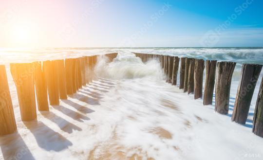 Two parallel rows of weathered wooden breakwaters at the beach  : Stock Photo or Stock Video Download rcfotostock photos, images and assets rcfotostock | RC Photo Stock.: