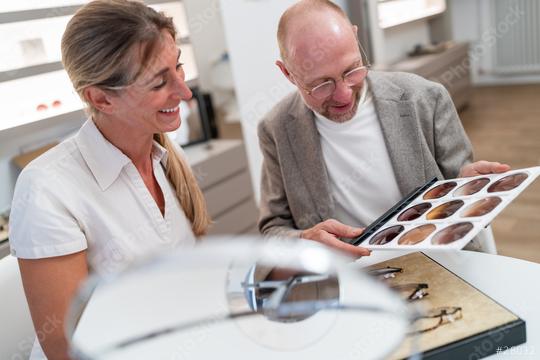 Two people examining eyeglasses on a display in an optical store
.  : Stock Photo or Stock Video Download rcfotostock photos, images and assets rcfotostock | RC Photo Stock.: