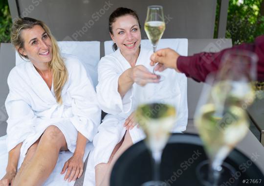 Two women in white bathrobes toasting with champagne served by a waiter in spa wellness resort   : Stock Photo or Stock Video Download rcfotostock photos, images and assets rcfotostock | RC Photo Stock.: