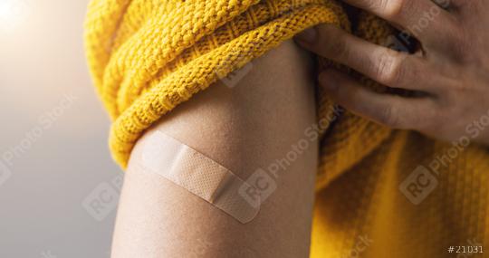 vaccine for corona COVID-19 and SARS cov. Woman holding up her sweater sleeve and showing her arm with Adhesive bandage Plaster after receiving vaccination injection, banner size  : Stock Photo or Stock Video Download rcfotostock photos, images and assets rcfotostock | RC Photo Stock.: