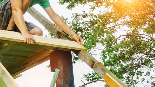 versatile craftsman working with wood to build a house on a summer day, DIY concept  : Stock Photo or Stock Video Download rcfotostock photos, images and assets rcfotostock | RC Photo Stock.: