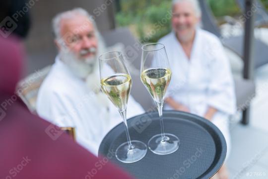 Waiter offering champagne to a smiling senior couple in white bathrobes at a hotel  : Stock Photo or Stock Video Download rcfotostock photos, images and assets rcfotostock | RC Photo Stock.: