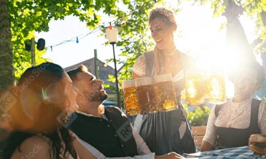 Waitress getting beer to patrons of beer garden or oktoberfest in Bavaria, Germany,  : Stock Photo or Stock Video Download rcfotostock photos, images and assets rcfotostock | RC Photo Stock.: