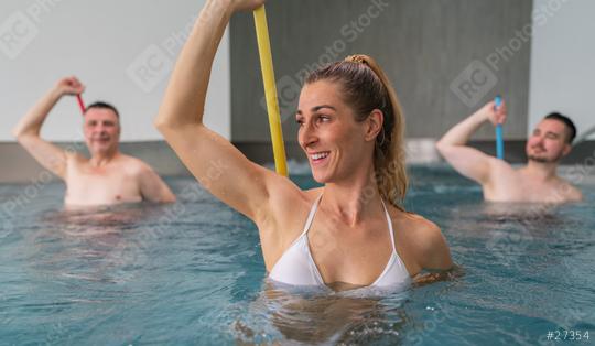 water aerobics class with three adults using resistance bars, focused and smiling in the pool. Sports and gymnastics under water in spa resort.  : Stock Photo or Stock Video Download rcfotostock photos, images and assets rcfotostock | RC Photo Stock.: