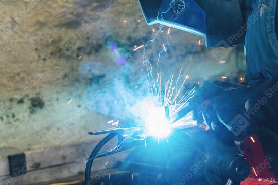 welder is welding metal part in car garage  : Stock Photo or Stock Video Download rcfotostock photos, images and assets rcfotostock | RC Photo Stock.: