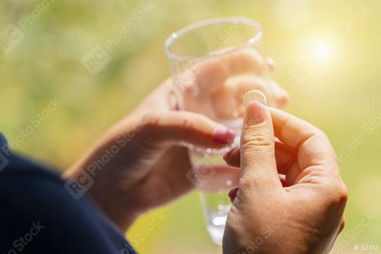 white pill and a glass of water in female hands. health concept image  : Stock Photo or Stock Video Download rcfotostock photos, images and assets rcfotostock | RC Photo Stock.: