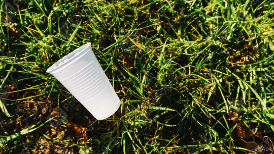 white Plastic cup pollution on a meadow. copyspace for your individual text  : Stock Photo or Stock Video Download rcfotostock photos, images and assets rcfotostock | RC Photo Stock.: