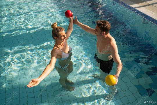 Woman and man in pool lifting colorful exercise balls above water in a sunny rehabilitation session  : Stock Photo or Stock Video Download rcfotostock photos, images and assets rcfotostock | RC Photo Stock.: