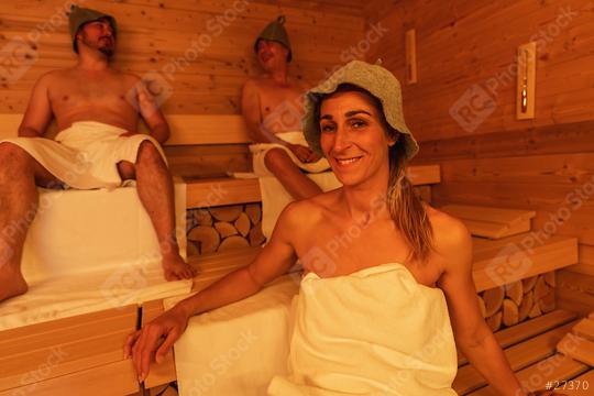 woman and two men wearing felt hats sitting in a wooden finnish sauna, warm ambient lighting  : Stock Photo or Stock Video Download rcfotostock photos, images and assets rcfotostock | RC Photo Stock.: