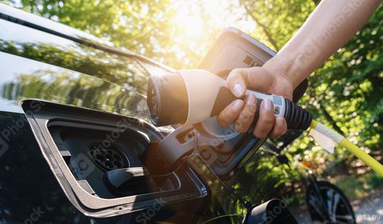 woman Charging battery of an electric car  : Stock Photo or Stock Video Download rcfotostock photos, images and assets rcfotostock | RC Photo Stock.: