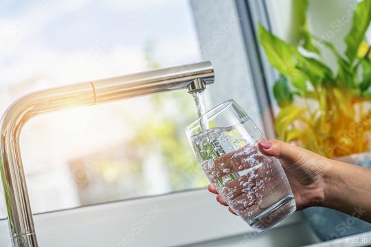 Woman filling a glass of water from a stainless steel or chrome tap or faucet, close up on her hand and the glass with running water and air bubbles  : Stock Photo or Stock Video Download rcfotostock photos, images and assets rcfotostock | RC Photo Stock.: