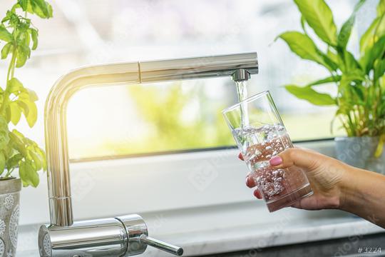 Woman filling glass with water from faucet in kitchen  : Stock Photo or Stock Video Download rcfotostock photos, images and assets rcfotostock | RC Photo Stock.: