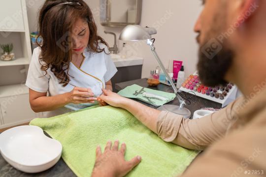 Woman giving a manicure to man in a beauty salon. body care spa treatment concept image  : Stock Photo or Stock Video Download rcfotostock photos, images and assets rcfotostock | RC Photo Stock.: