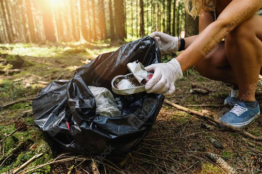 woman hand picking up a canned tin to clean up the forest from garbage. nature and environment cleaning concept image.  : Stock Photo or Stock Video Download rcfotostock photos, images and assets rcfotostock | RC Photo Stock.:
