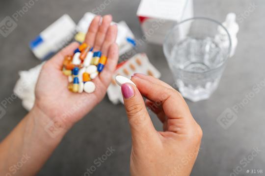 Woman hands holding heap of small round meds with glass of water before taking medication  : Stock Photo or Stock Video Download rcfotostock photos, images and assets rcfotostock | RC Photo Stock.: