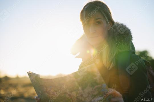 Woman hiker with a backpack and a map , searching right direction in the wilderness at sunset  : Stock Photo or Stock Video Download rcfotostock photos, images and assets rcfotostock | RC Photo Stock.: