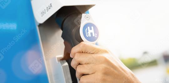 Woman hold a fuel dispenser with hydrogen logo on gas station. h2 combustion engine for emission free eco friendly transport concept image  : Stock Photo or Stock Video Download rcfotostock photos, images and assets rcfotostock | RC Photo Stock.: