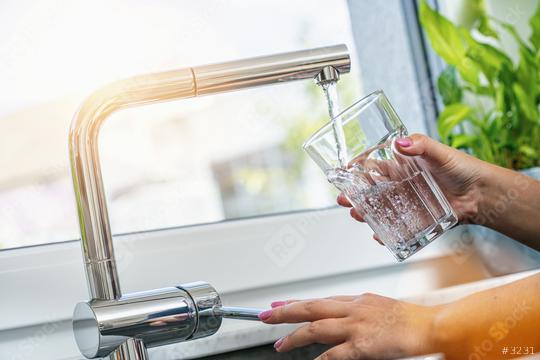 woman holding glass at water tap and filling water  : Stock Photo or Stock Video Download rcfotostock photos, images and assets rcfotostock | RC Photo Stock.: