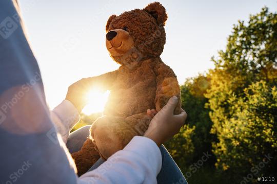 Woman holding teddy bear toy with sunlight at sunset  : Stock Photo or Stock Video Download rcfotostock photos, images and assets rcfotostock | RC Photo Stock.: