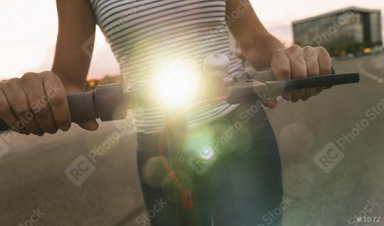 woman holds electric kick scooter or e-scooter with lamp at night in the city, Electric urban transportation concept image  : Stock Photo or Stock Video Download rcfotostock photos, images and assets rcfotostock | RC Photo Stock.: