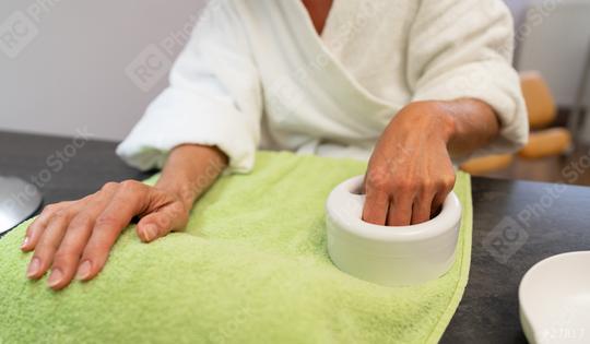 Woman in a bathrobe soaking hand in a bowl at a nail salon spa  : Stock Photo or Stock Video Download rcfotostock photos, images and assets rcfotostock | RC Photo Stock.: