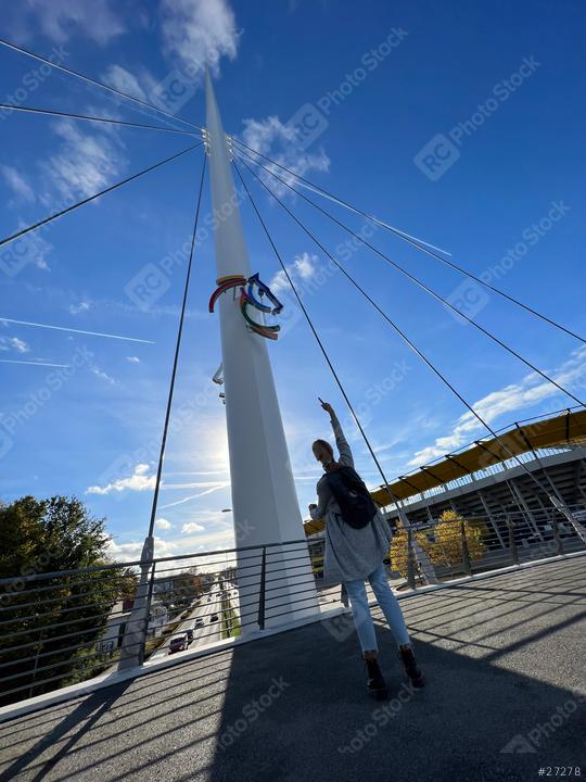 woman in a gray cardigan and jeans stands on a bridge, looking up at a colorful horse emblem on a pole, with a blue sky and a modern bridge with chio sign in the background
  : Stock Photo or Stock Video Download rcfotostock photos, images and assets rcfotostock | RC Photo Stock.: