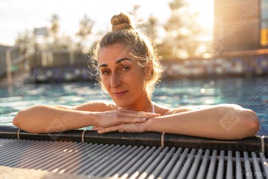 Woman in a pool at a resort, leaning on the edge, sunlit backgro  : Stock Photo or Stock Video Download rcfotostock photos, images and assets rcfotostock | RC Photo Stock.: