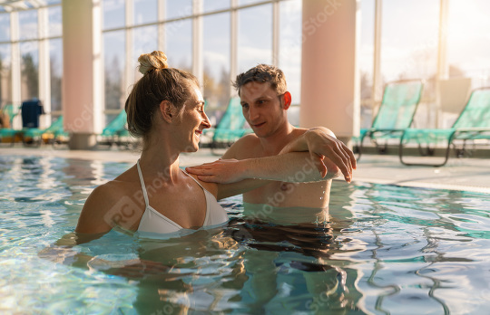 woman in a white swimsuit smiles at a male trainer during a shou  : Stock Photo or Stock Video Download rcfotostock photos, images and assets rcfotostock | RC Photo Stock.:
