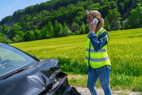 Woman in high visibility vest on phone with damaged car in foreground showing accident site on rural road  : Stock Photo or Stock Video Download rcfotostock photos, images and assets rcfotostock | RC Photo Stock.: