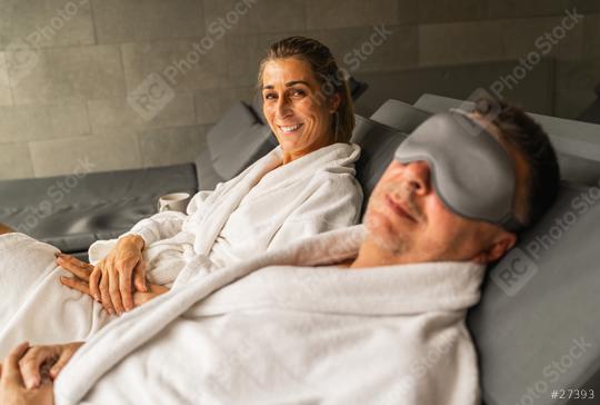 Woman in spa gown smiling, man beside her with sleeping mask, both reclining  : Stock Photo or Stock Video Download rcfotostock photos, images and assets rcfotostock | RC Photo Stock.: