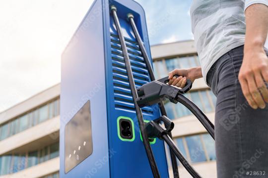 woman insert a DC - CCS type 2 EV charging connector at EV charg  : Stock Photo or Stock Video Download rcfotostock photos, images and assets rcfotostock | RC Photo Stock.: