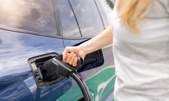 Woman inserting a DC CCS2 EV charging connector into electric ca  : Stock Photo or Stock Video Download rcfotostock photos, images and assets rcfotostock | RC Photo Stock.: