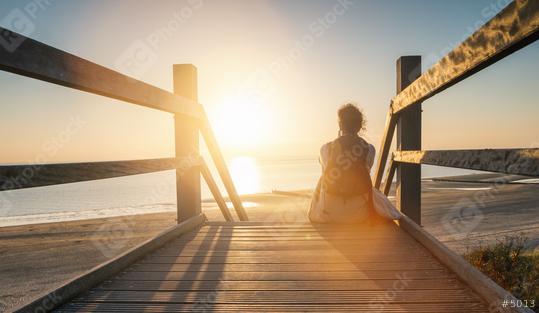 woman is sitting on a wooden path to the Baltic sea at sunset an  : Stock Photo or Stock Video Download rcfotostock photos, images and assets rcfotostock | RC Photo Stock.: