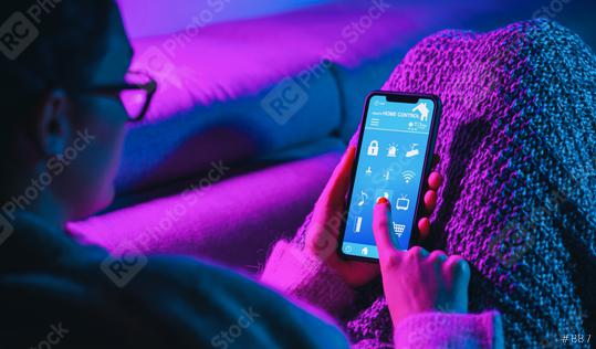 Woman lies on sofa and to unlock the door of his house. smart home technology interface in a smartphone screen application. Hand holding smart device.   : Stock Photo or Stock Video Download rcfotostock photos, images and assets rcfotostock | RC Photo Stock.:
