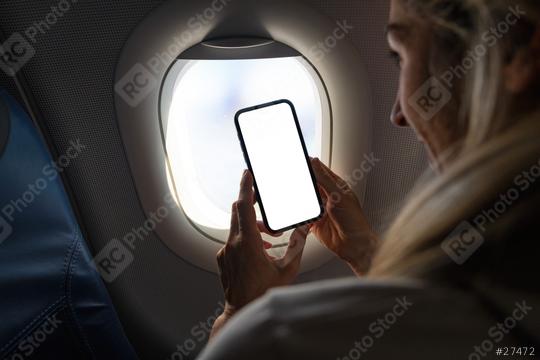 Woman on airplane holding mobile phone in hands with blank desktop screen by the window to take a photo Mockup image with copy space  : Stock Photo or Stock Video Download rcfotostock photos, images and assets rcfotostock | RC Photo Stock.: