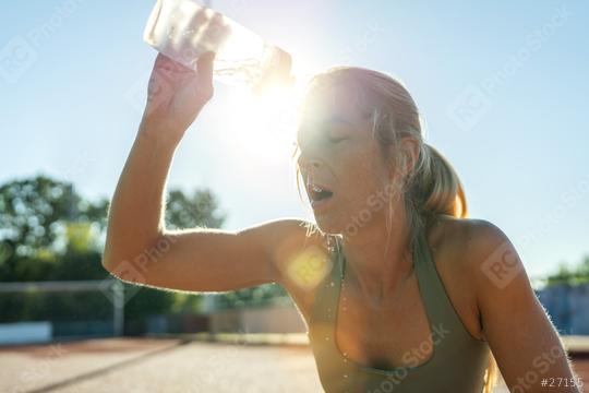 Woman pouring water on face after workout, sun flare, sports bottle, refreshing  : Stock Photo or Stock Video Download rcfotostock photos, images and assets rcfotostock | RC Photo Stock.: